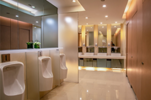 High-end corporate restroom with polished floor tiles and modern fixtures.